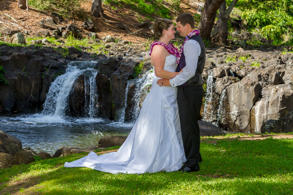 Couple looking at each other by a waterfall