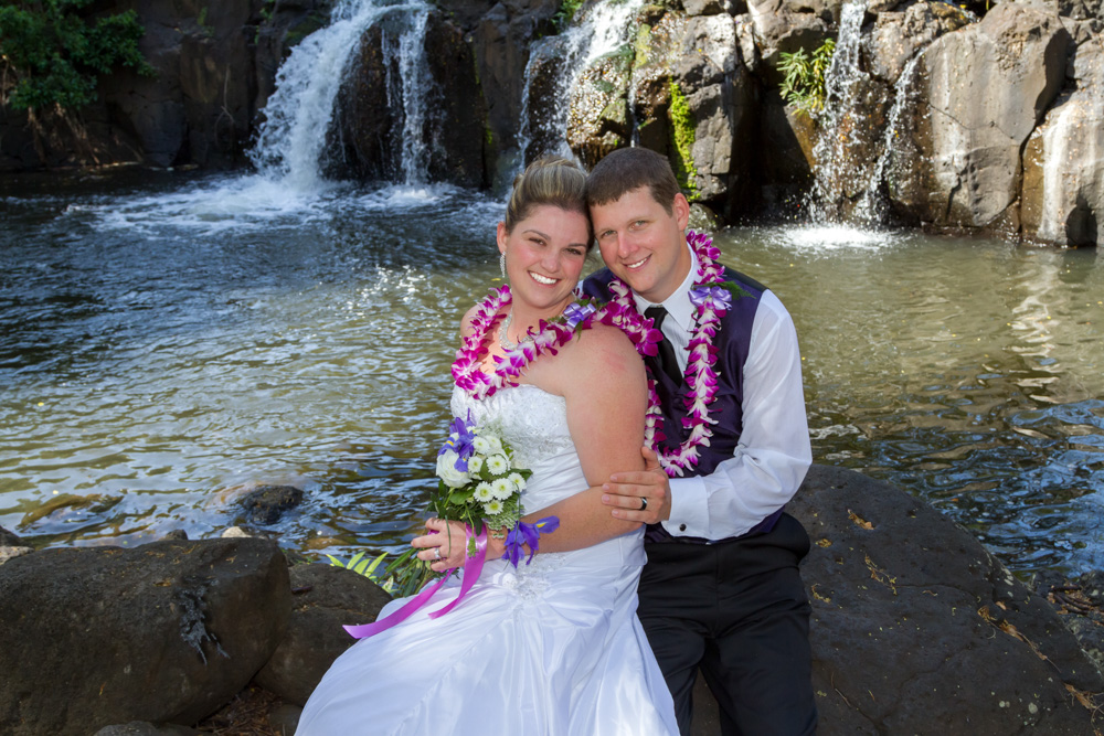 Couple on the rocks by a waterfall