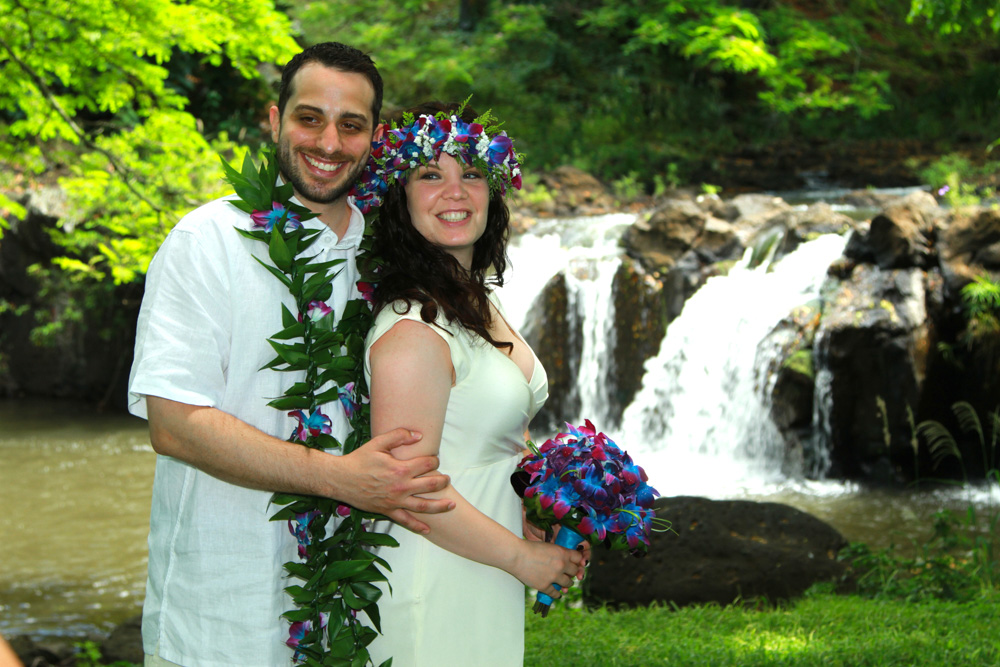 Beautiful couple with flowing waterfall behind them