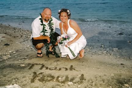 Couple with thank you written in sand