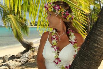 Bride in flowers looking out to sea