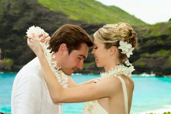 Bride putting lei on groom