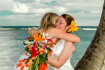 Guest hugging newly wed bride