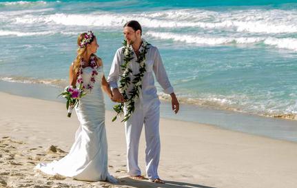 Newlyweds walking by the sea